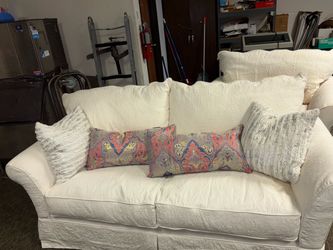 White loveseat and overstuffed chair