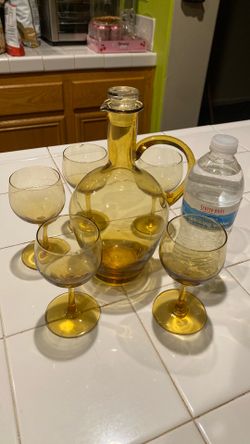 Old bottle with  5 cups  in very good condition $15 dollars