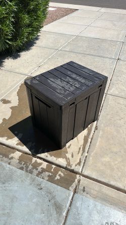 Small Keter deck box measuring 23 inches long by 21 inches high and 18 inches wide