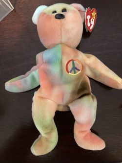 Ty beanie baby called peace with tags. Attached has been stored in a clear acrylic box not played with.