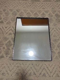 Mirror with metal frame