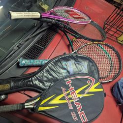 A Variety Of Tennis Rackets Complete With A Ball Retriever