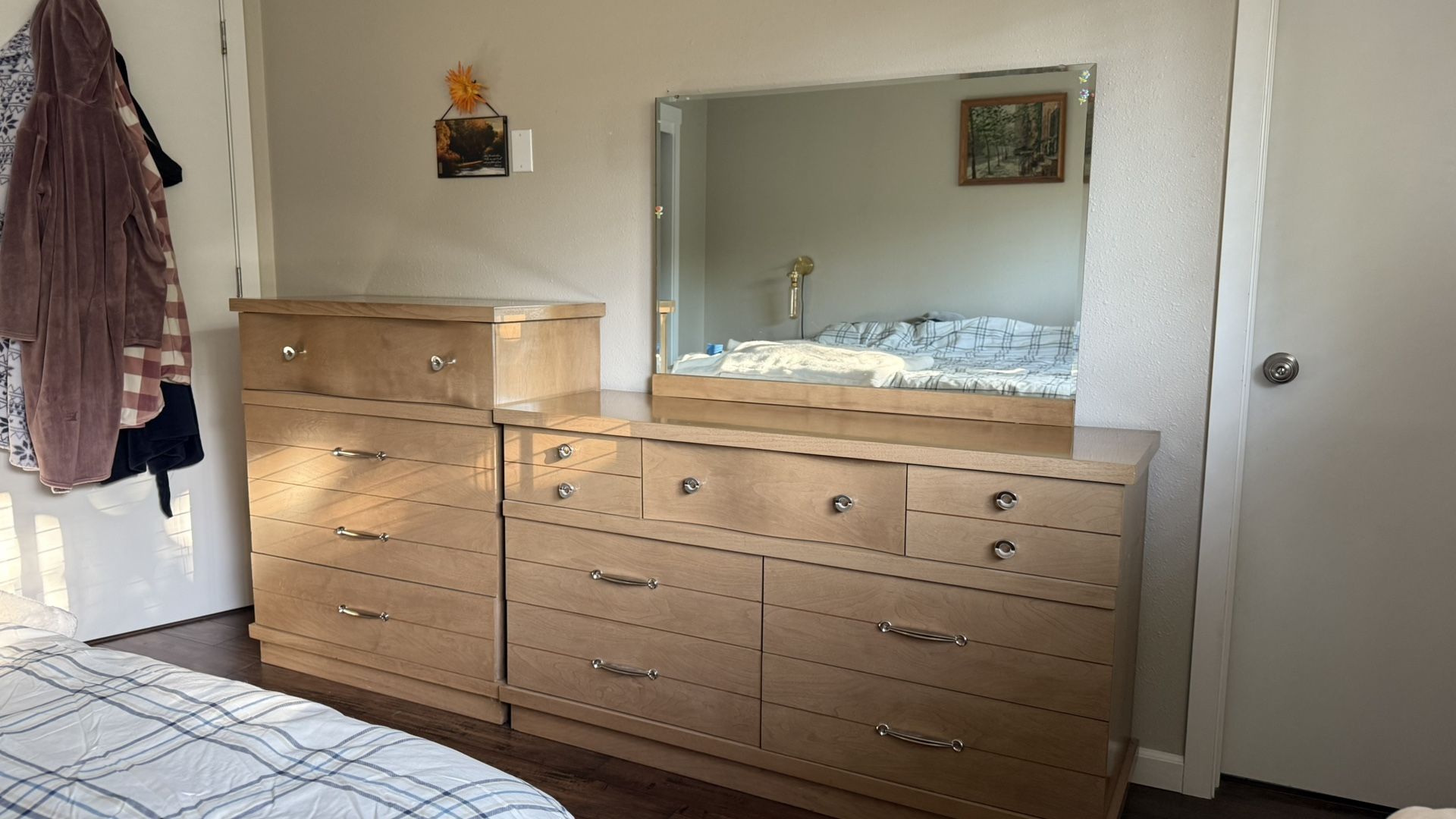 Two dressers with a mirror.