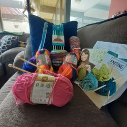 Bundle Of Knitting Supplies With Needles And Instructions