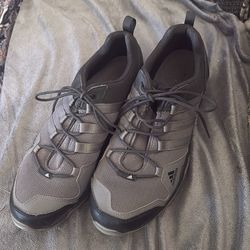 These are Adidas Terrex AX2R hiking shoes, designed for all-terrain use with a lightweight EVA midsole for cushioning and a Traxion outsole for grip