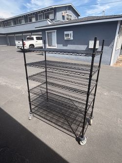 Black heavy-duty 5-shelf wire racking unit on smooth-rolling casters