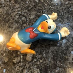 Vintage Disney Donald Duck Soft Rubber Toy Figure Arms Up Stretched Over His Head.  Very old.  Size 5 inches long. Preowned good condition.  