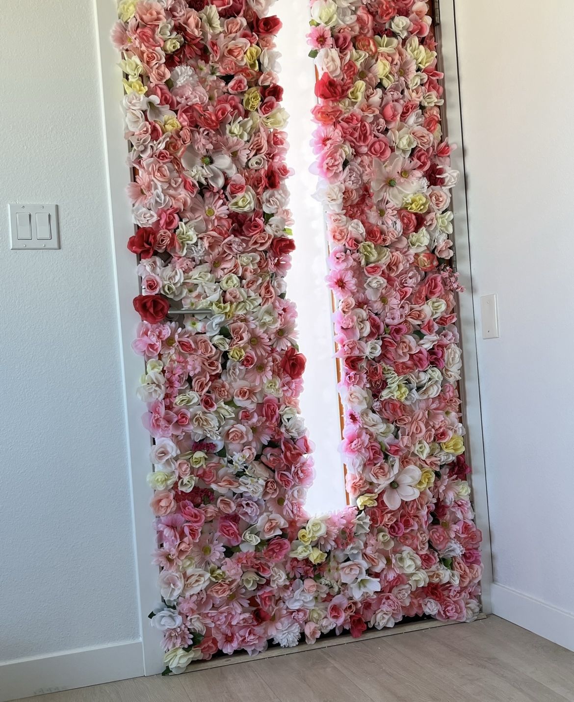 $250/worth of artificial flowers on styrofoam panels - flower wall