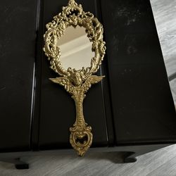 Vintage or antique ornate hand mirror
