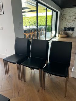 Set of Black faux Leather Dining Chairs with Chrome Legs