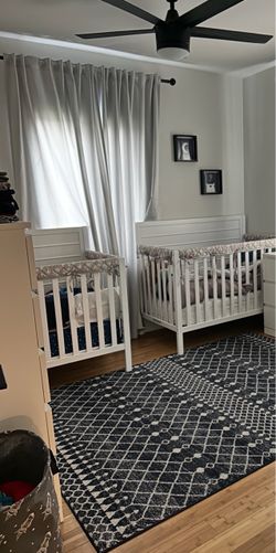 Two white solid wood cribs