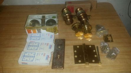 Box of dead bolts, door knobs, and hinges. Brand new