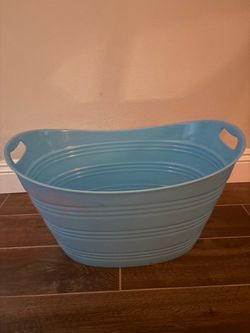 Large light blue oval plastic storage and beverage tub