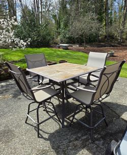Outdoor tile table and swivel chairs