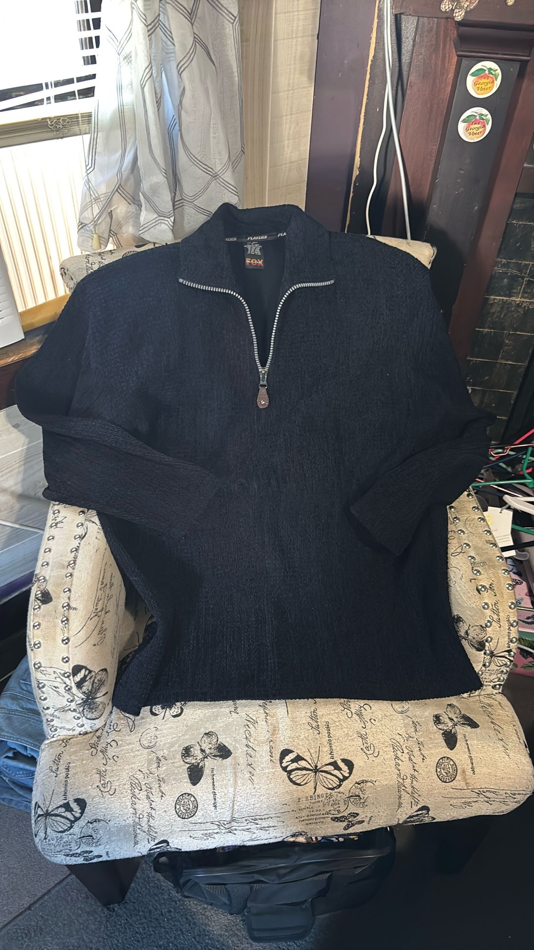 A black quarter-zip sweater by F/X Fusion