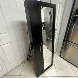 freestanding mirrored jewelry armoire,  a jewelry cabinet 