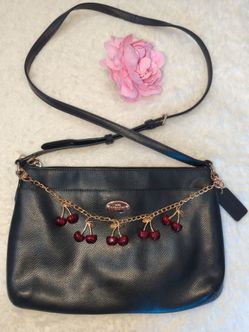 Coach leather cross body bag with cherry charm chain