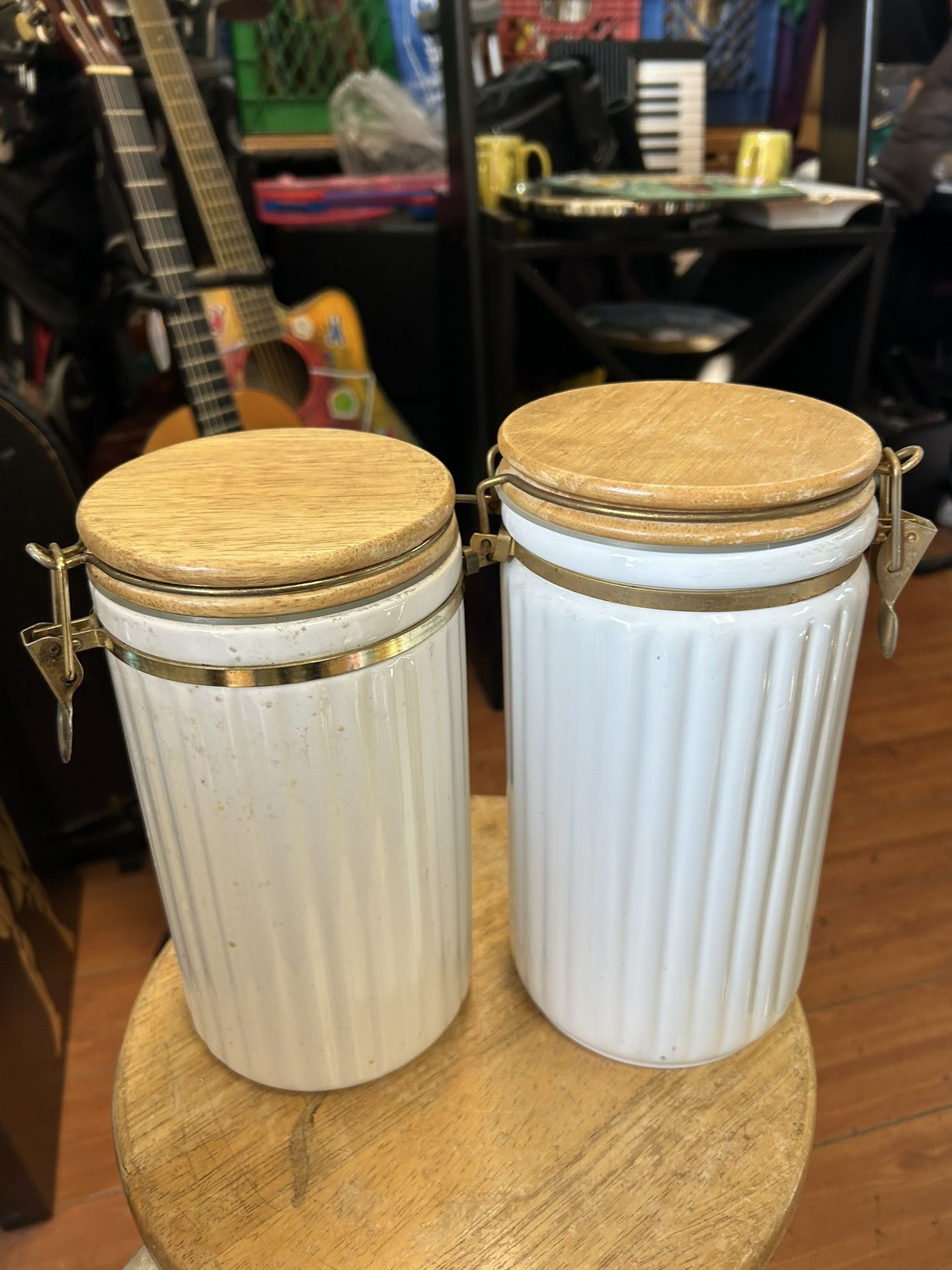 Set of ceramic kitchen canisters with wooden lids and metal latches