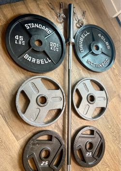 6 ft Steel NEW Olympic Bar with Pairs of Weight Plates in New Condition 45s, 35s, 25s, 10s and 5s. Total: 282 lbs