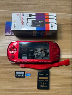 RED PSP 3000 with 100 games installed.             N04