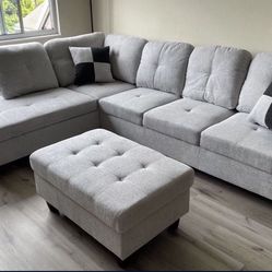 Gray linen sectional couch and ottoman