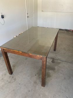 Solid wood dining table with glass top