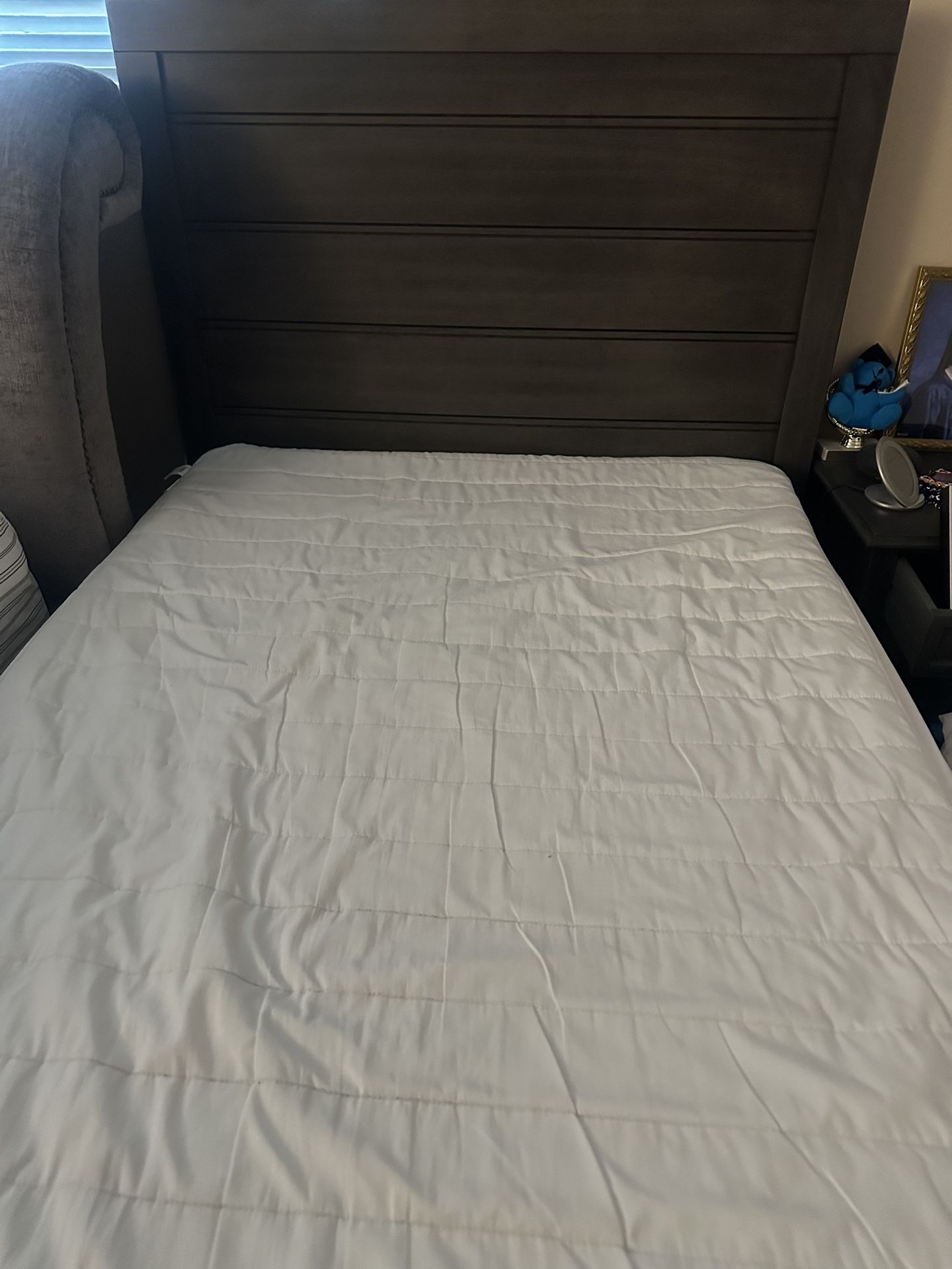brown bed frame and mattress