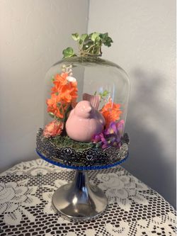 Joyful pink colored bird in paradise and flowers