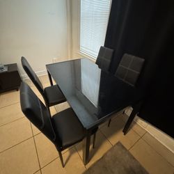 Black table with four chairs