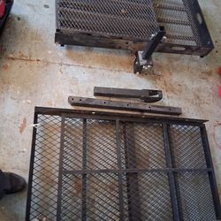 hitch-mounted mobility scooter or wheelchair carrier with a loading ramp.