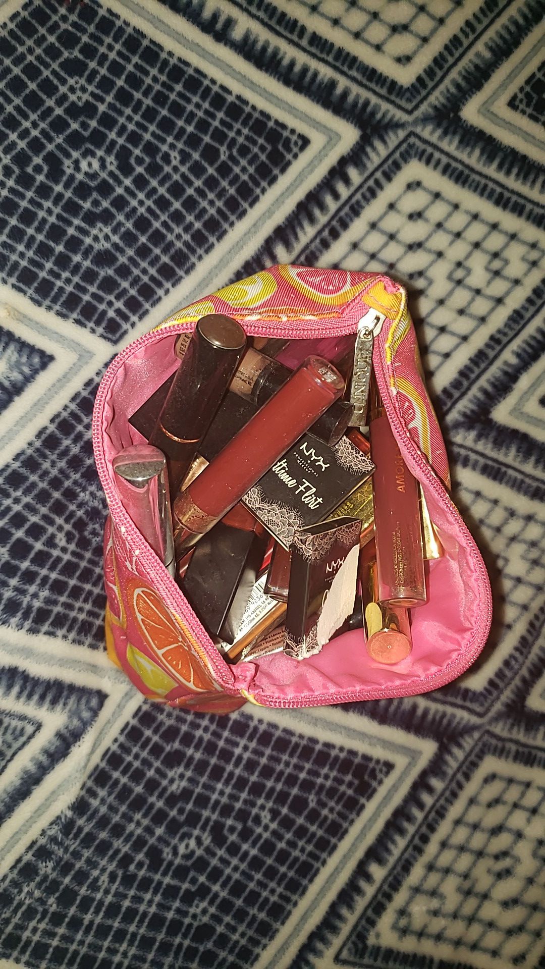 Makeup bag full of liquid lipstick and makeup brushes