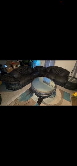 Black Sectional Sofa with Round Glass Coffee Table