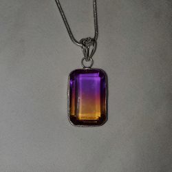Purple to yellow gradient stone on silver chain.
