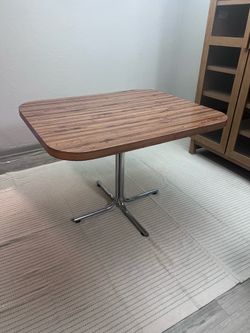 Dining table with chrome pedestal legs