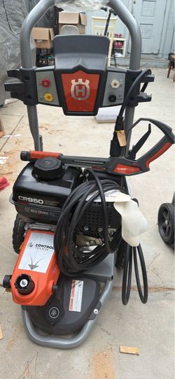 Powerful Husqvarna gas-powered pressure washer features a Briggs & Stratton CR950 208cc engine. This unit has a grey metal frame with orange and black