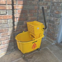 Yellow cleaning bucket with removable mop wringer