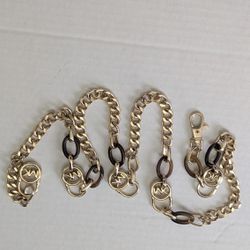 Michael Kors chain belt featuring metal links and an MK logo clasp. 