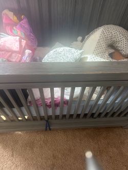 Grey wooden crib