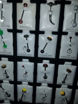 Belly eye brow tongue chin piercing