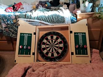 Dart board with 2 nice dart sets(metal) and a spare