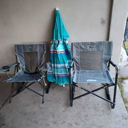 Two chairs with shock absorbers and a parasol