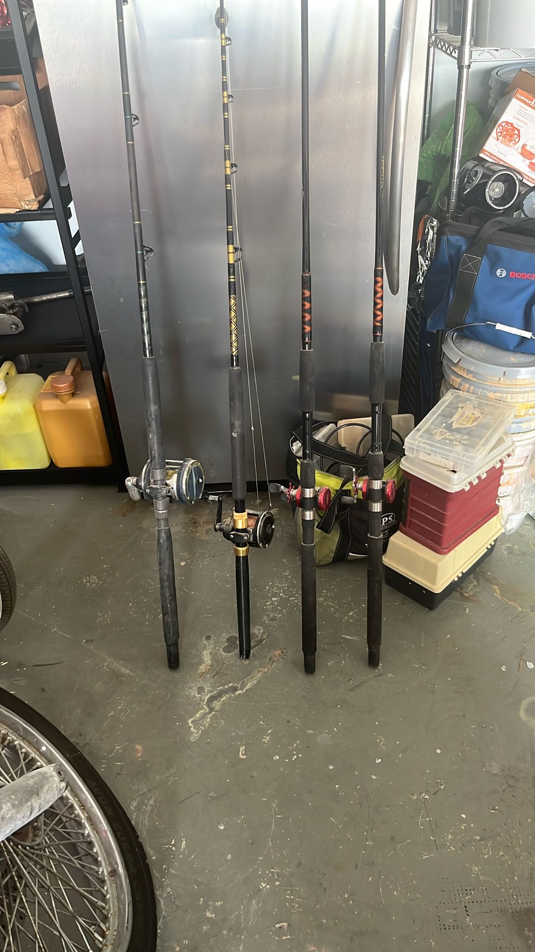 Two bottom fishing rods with reels and two bait sticks