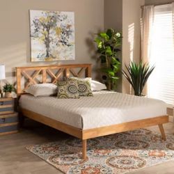 platform bed with a brown finish and a crisscross headboard design.(New)