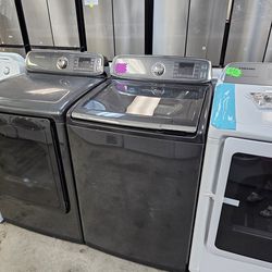SAMSUNG STEAM BLACK STAINLESS STEEL TOP LOAD WASHER AND GAS DRYER SET WITH MIDDLE GASKET 