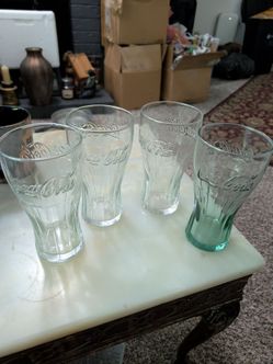 Four Coca-Cola glasses