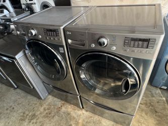 Graphite steel front load lg steam washer and front load lg steam dryer with pedestals  working perfectly with warranty extra for delivery same day de