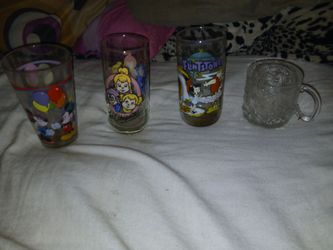 Four collectibles drinking glasses and collectible vcr kids movies