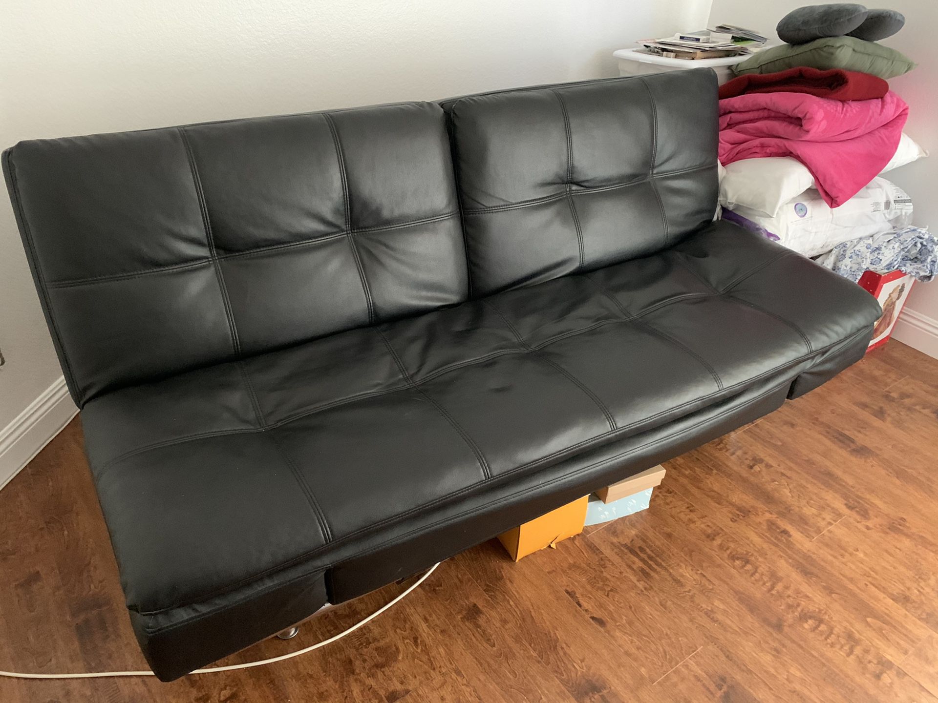 Black leather Futon opens up to a full size