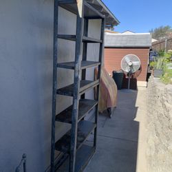 A metal shelf made of iron that can withstand heavy weights, with a length of 7 feet and a width of 3 feet.