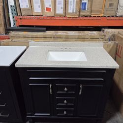 Black bathroom vanity with sink and countertop